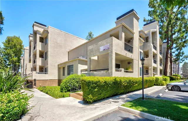 a view of a white house with a yard and plants