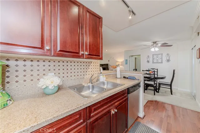 a kitchen with a sink cabinets and wooden floor