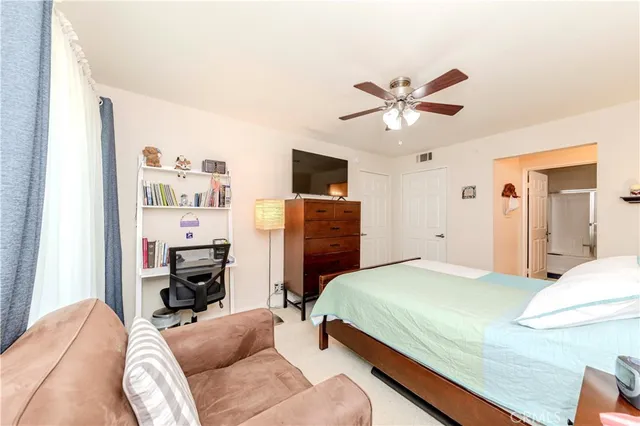 a bedroom with a bed and a television