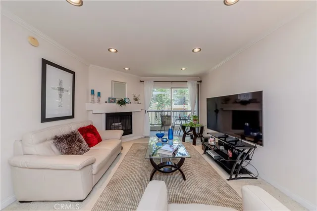 a living room with furniture flat screen tv and a fireplace