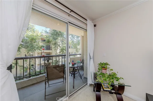 a balcony with furniture and a potted plant