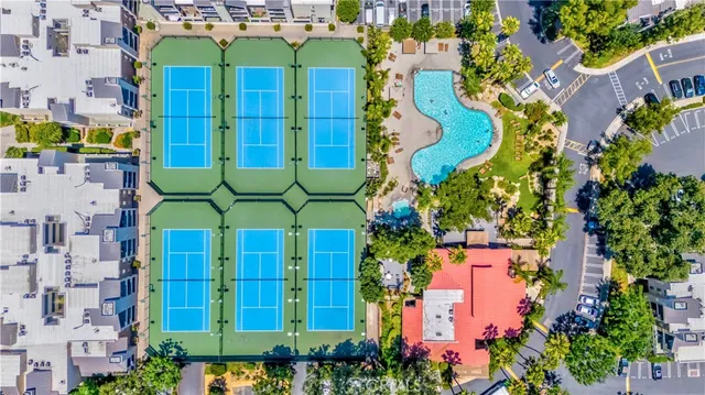 an aerial view of a building with yard and swimming pool