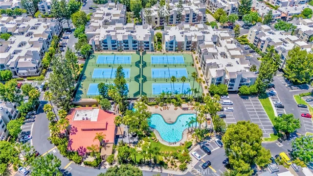 an aerial view of residential houses with outdoor space and swimming pool