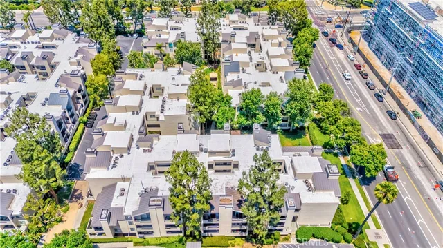 an aerial view of residential houses with plants and trees