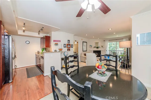 a view of a dining room and livingroom with furniture wooden floor a chandelier