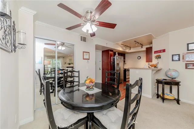 a view of a dining room with furniture and chandelier