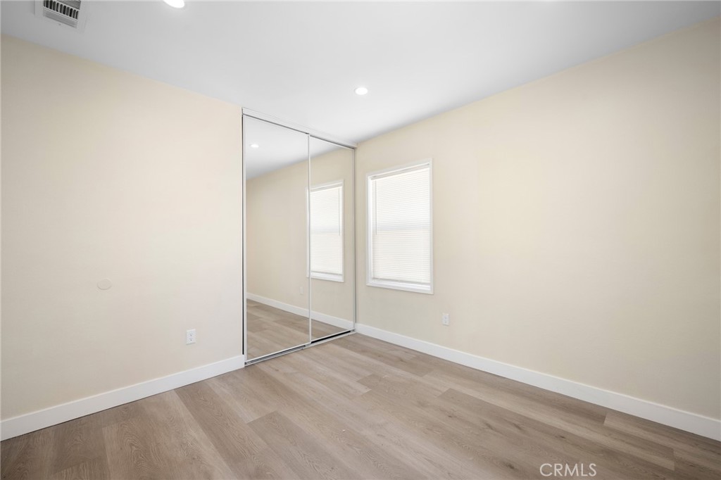 8435 Rincon Avenue Sun Valley, CA 91352 - Photo 14 of 61 an empty room with wooden floor and windows