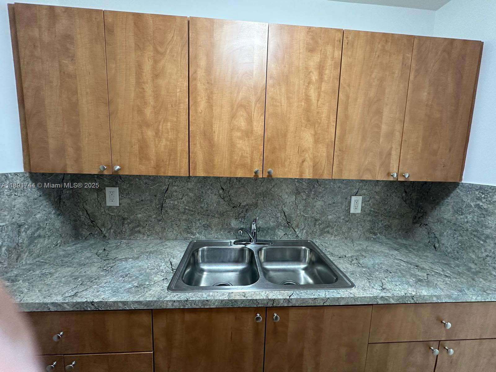 1100 Southwest 36th Court, Unit 10 Miami, FL 33135 - Photo 3 of 7 a kitchen with granite countertop a sink a granite counter and a grill