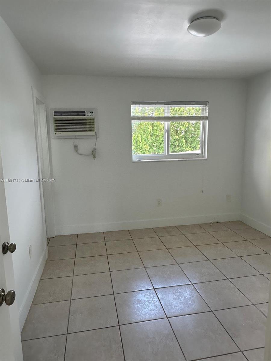 1100 Southwest 36th Court, Unit 10 Miami, FL 33135 - Photo 4 of 7 an empty room with white walls and tiles
