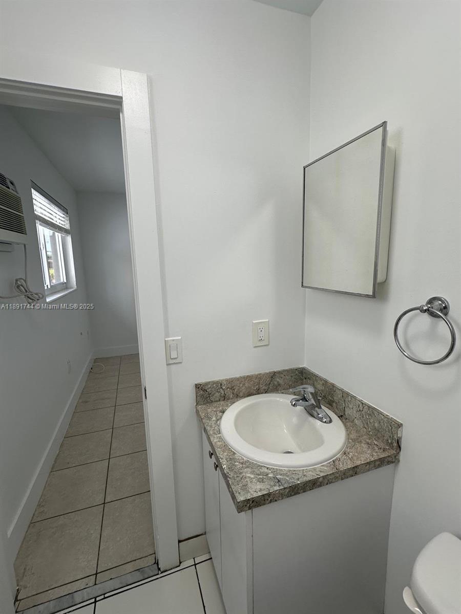 1100 Southwest 36th Court, Unit 10 Miami, FL 33135 - Photo 6 of 7 a bathroom with a sink and a toilet