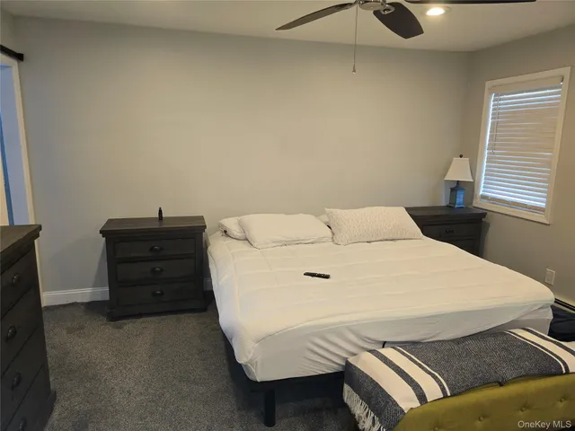 a bedroom with a bed and dresser