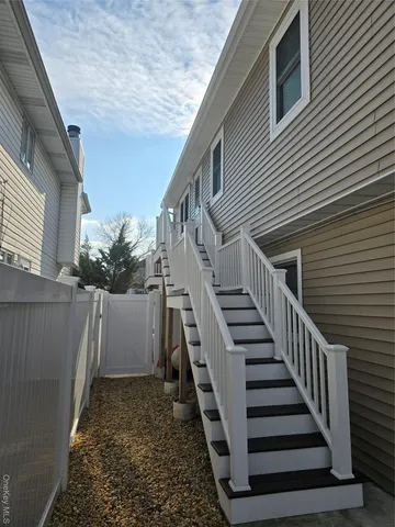 a view of a house with wooden fence