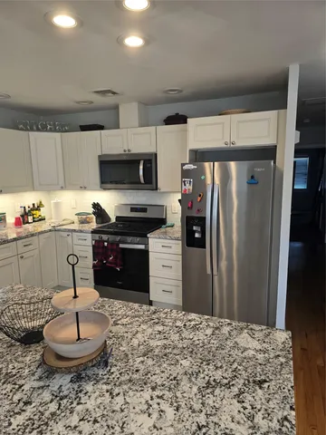 a kitchen with a refrigerator and a microwave