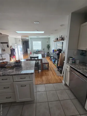 a living room with granite countertop furniture and a kitchen counter space
