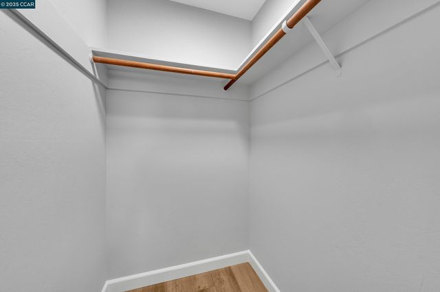 a bedroom with a bed and a lamp