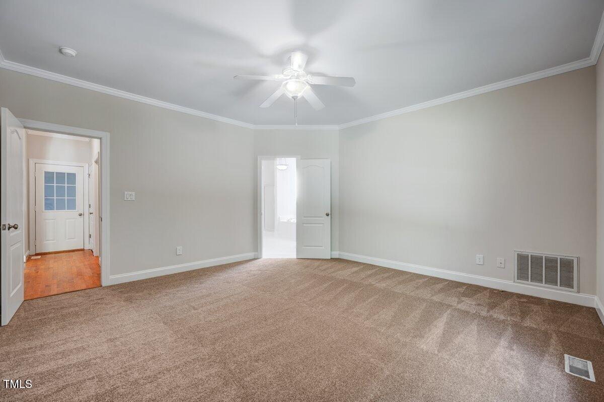 1321 Taylor Farm Road Raleigh, NC 27603 - Photo 23 of 41 a view of an empty room with chandelier fan and windows