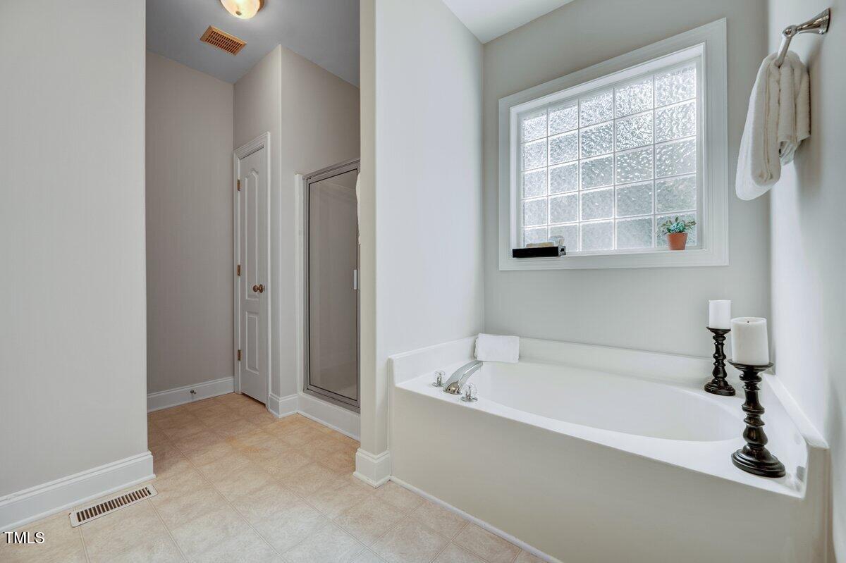 1321 Taylor Farm Road Raleigh, NC 27603 - Photo 25 of 41 a bathroom with a bathtub and a shower