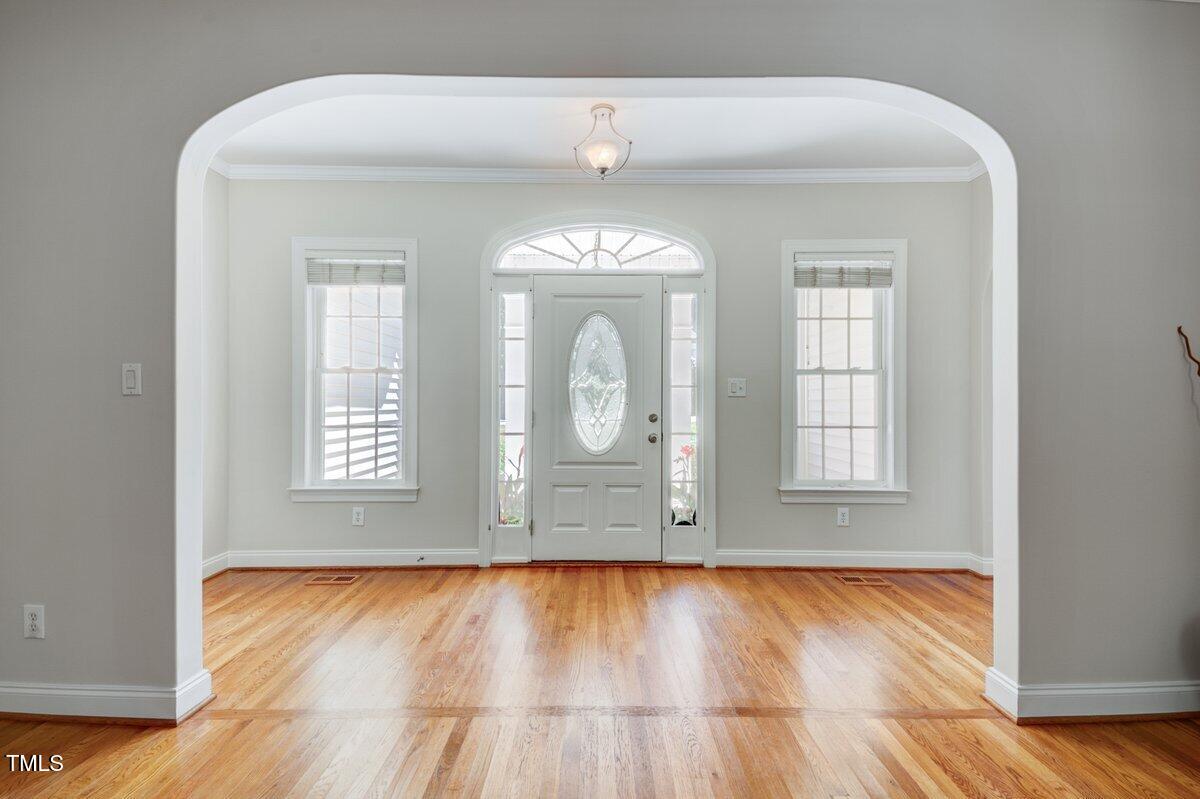 1321 Taylor Farm Road Raleigh, NC 27603 - Photo 5 of 41 an empty room with wooden floor and window