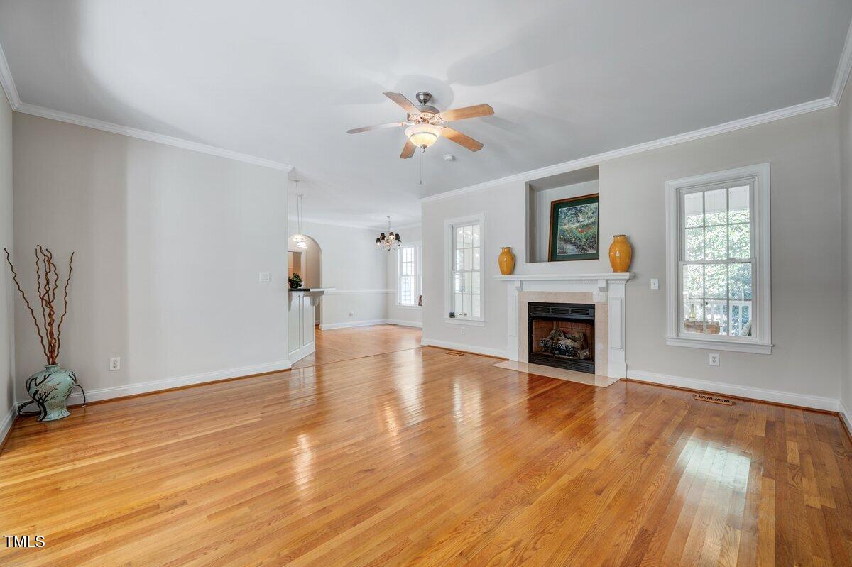 1321 Taylor Farm Road Raleigh, NC 27603 - Photo 8 of 41 a view of empty room with fireplace and wooden floor
