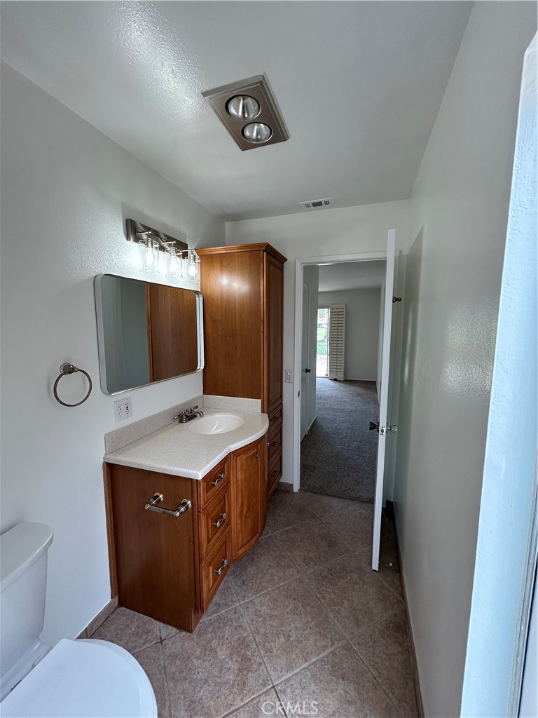 1915 Silver Oak Way Hemet, CA 92545 - Photo 11 of 17 a bathroom with a sink a toilet and mirror