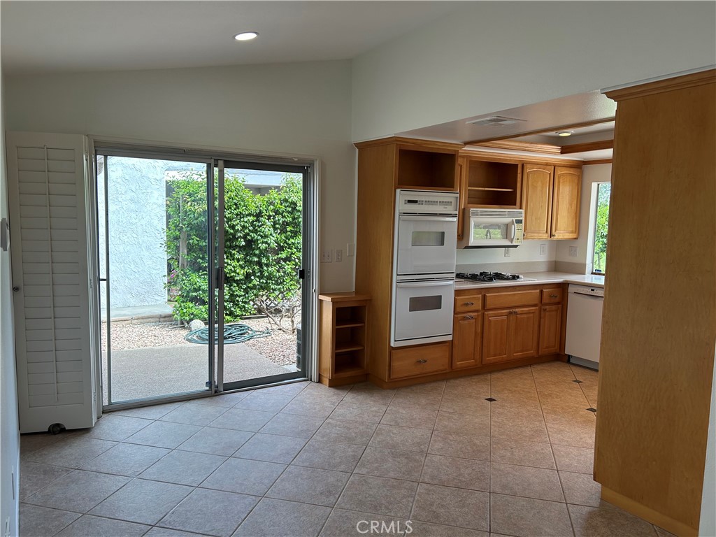 1915 Silver Oak Way Hemet, CA 92545 - Photo 3 of 17 a kitchen with stainless steel appliances a stove top oven and a refrigerator