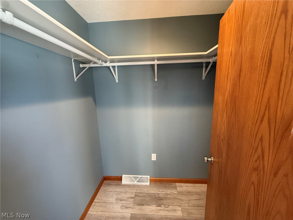6784 Old Zoarville Road Northeast Dover, OH 44622 - Photo 25 of 50 Walk in closet with wood finished floors