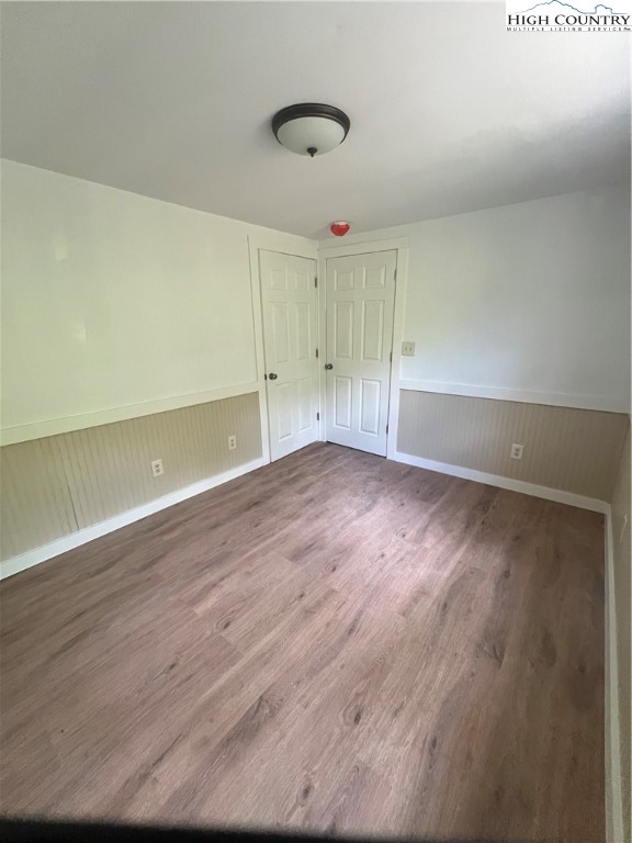 9635 Highway 194 Lansing, NC 28643 - Photo 19 of 28 wooden floor in an empty room