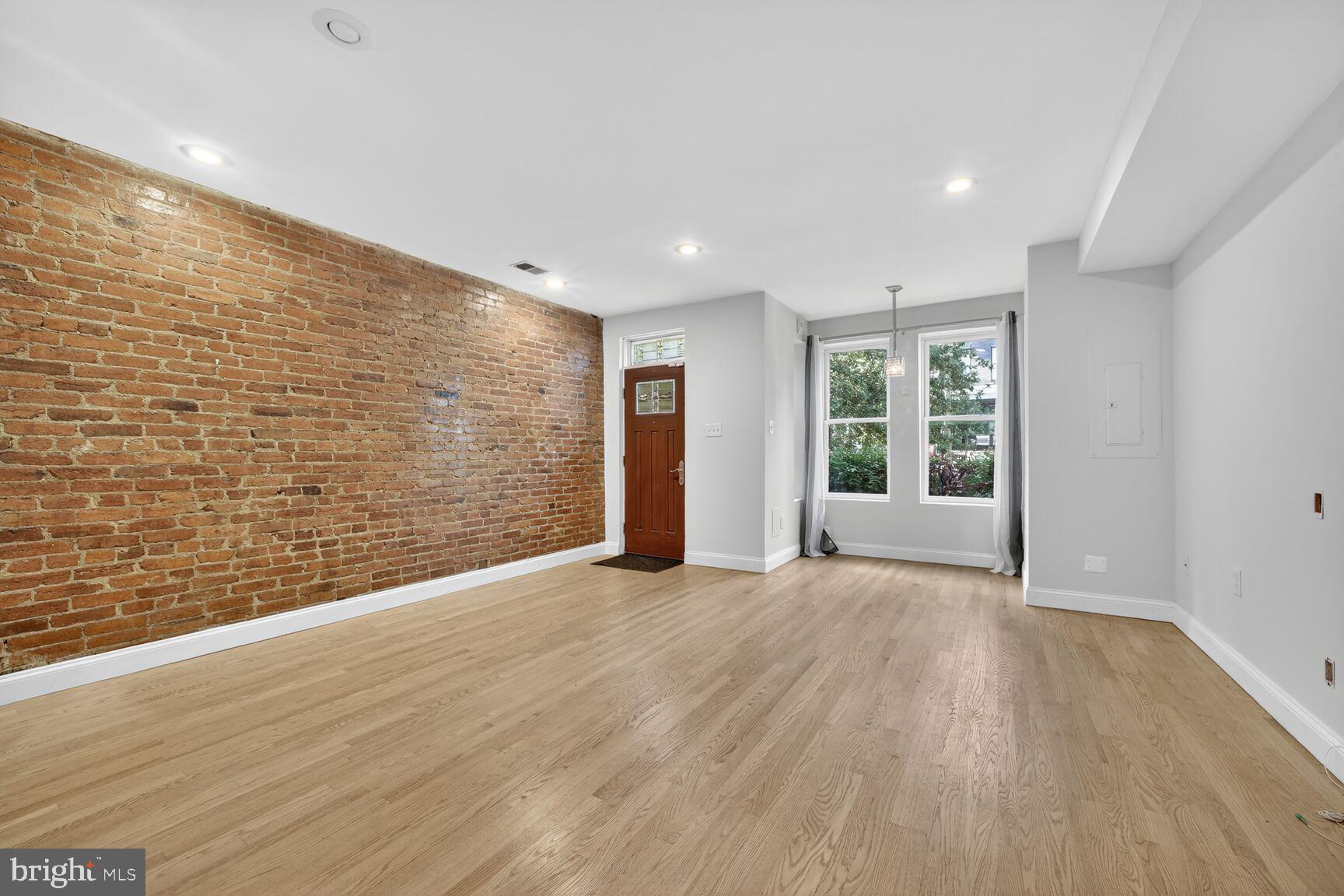 1251 I Street Northeast Washington, DC 20002 - Photo 16 of 31 a view of an empty room with wooden floor and a window