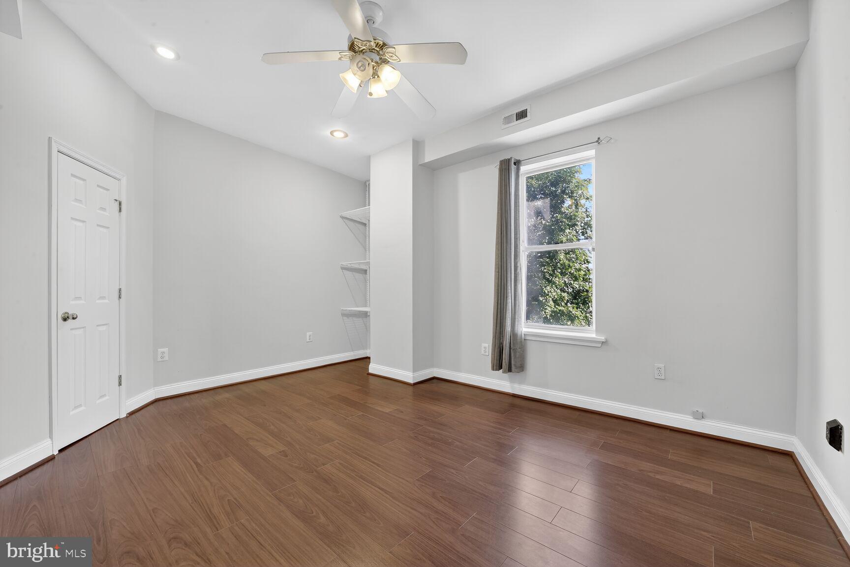 1251 I Street Northeast Washington, DC 20002 - Photo 24 of 31 an empty room with wooden floor and windows