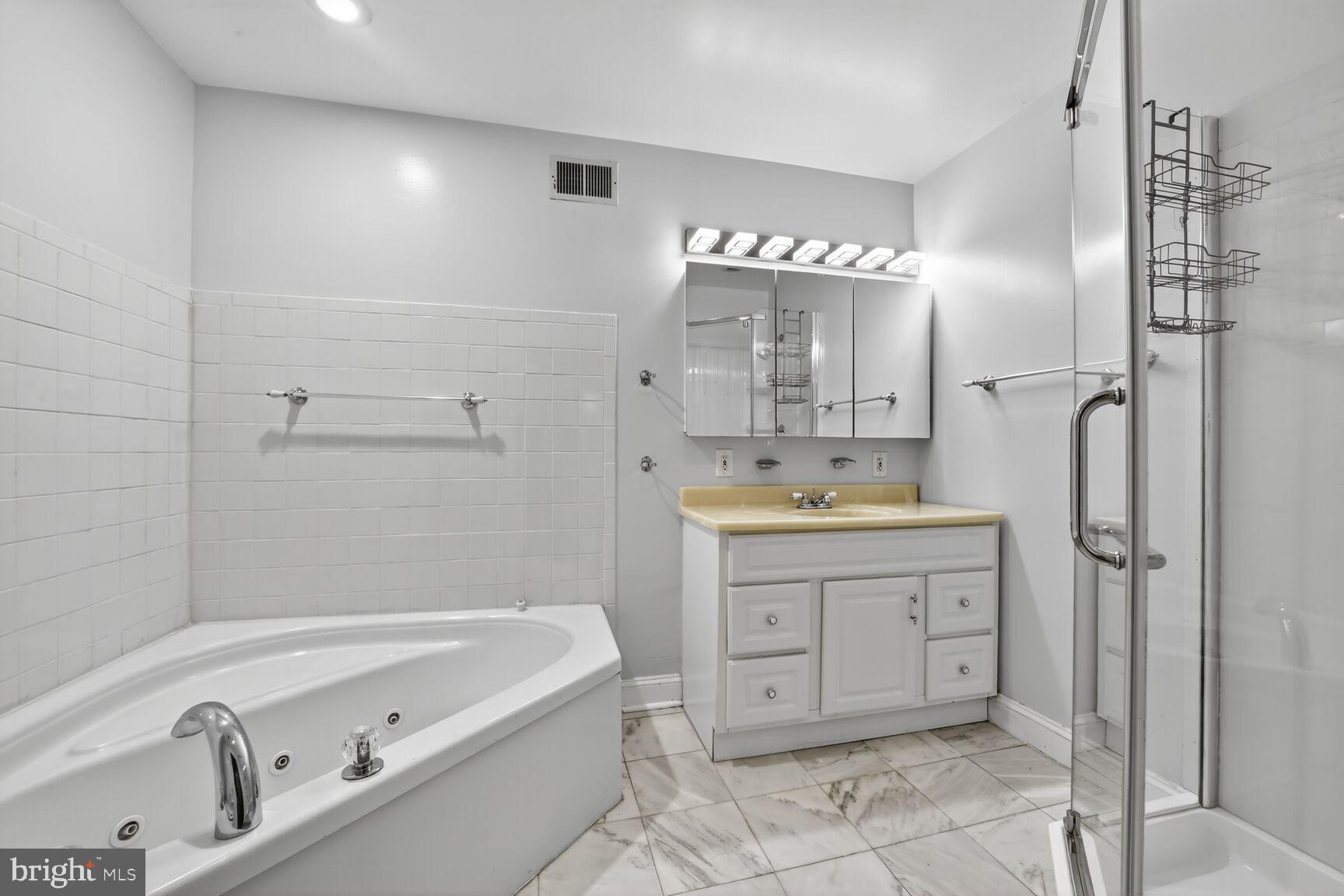 1251 I Street Northeast Washington, DC 20002 - Photo 26 of 31 a bathroom with a tub sink and mirror