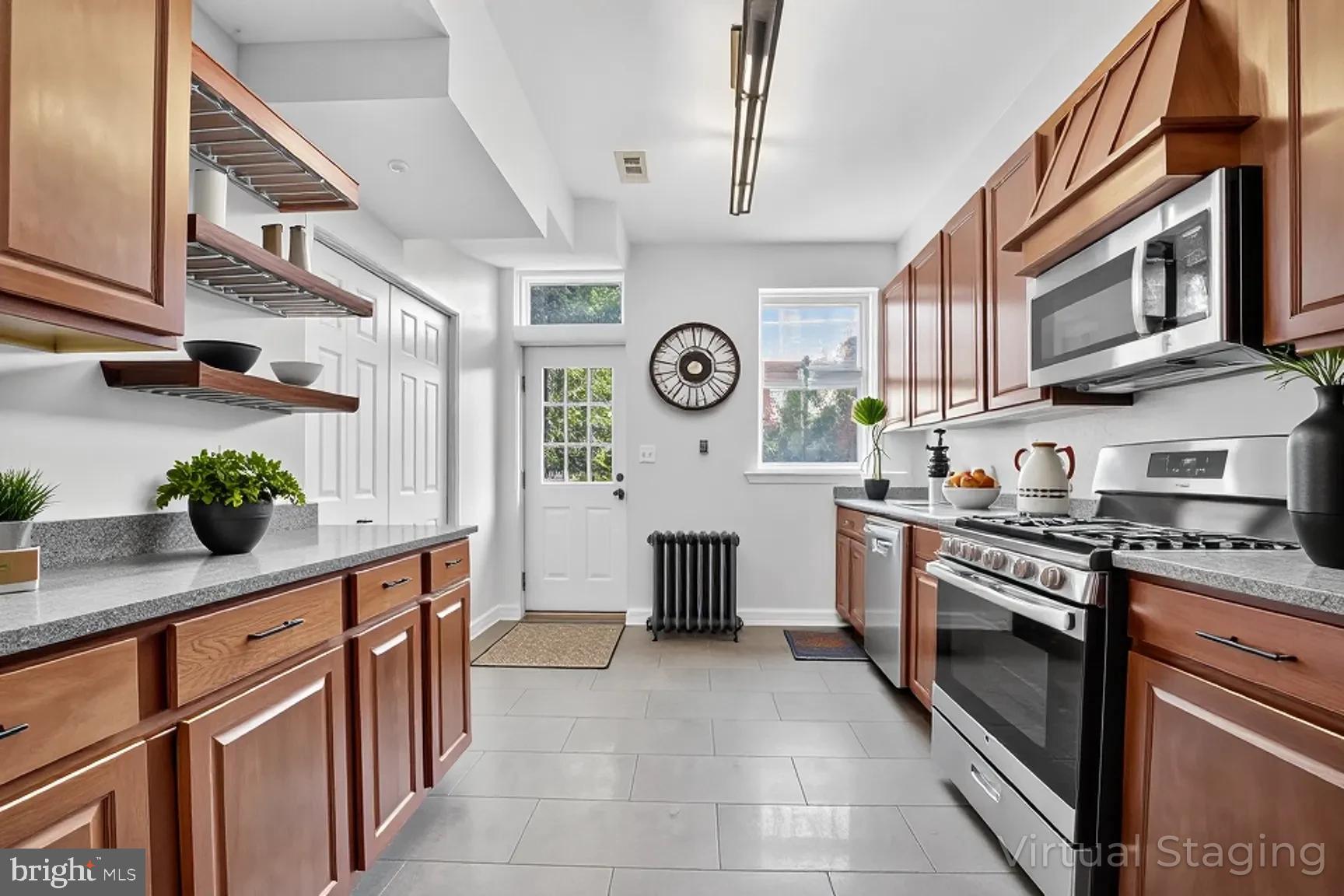 1251 I Street Northeast Washington, DC 20002 - Photo 6 of 31 a kitchen with stainless steel appliances granite countertop a stove a sink and a refrigerator