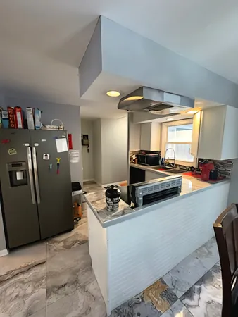 a kitchen that has a sink and a stove in it