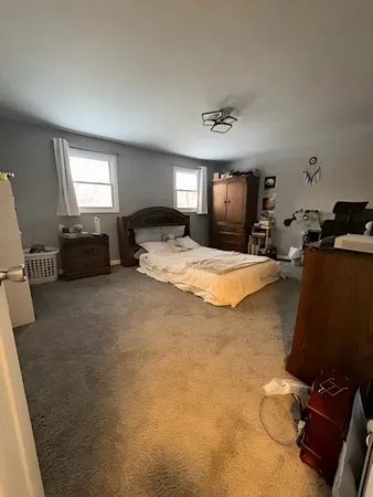 a bed room with furniture and a window