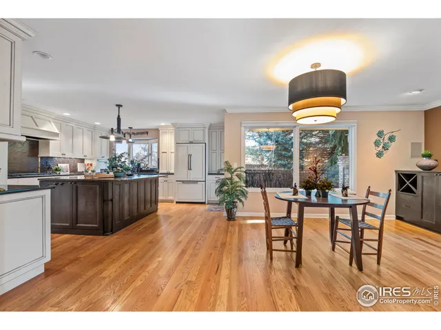 a living room with stainless steel appliances kitchen island granite countertop a dining table chairs and view living room