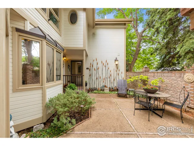 a backyard of a house with yard and outdoor seating