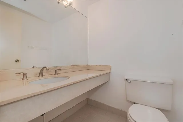 a kitchen with a sink a refrigerator a stove and cabinets