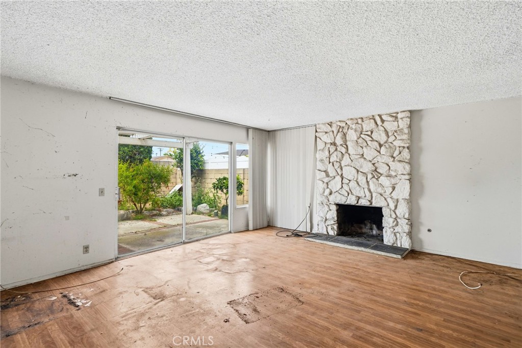 5131 Rotherham Circle Westminster, CA 92683 - Photo 22 of 50 a view of an empty room with a fireplace and a window