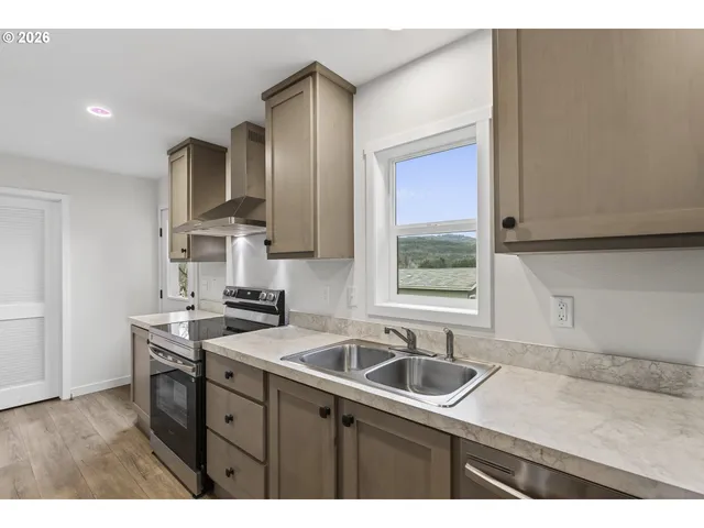 a kitchen that has a sink and a stove