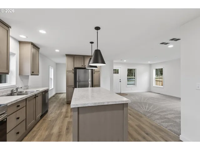 a kitchen with a sink a counter space and appliances