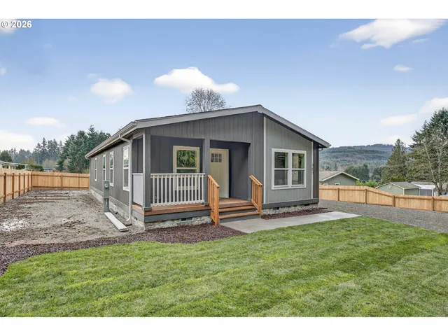a view of a house with a yard and sitting area