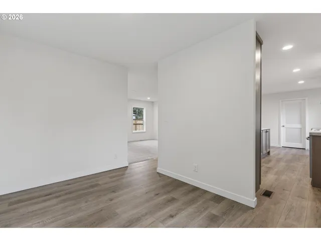 a view of an empty room and wooden floor