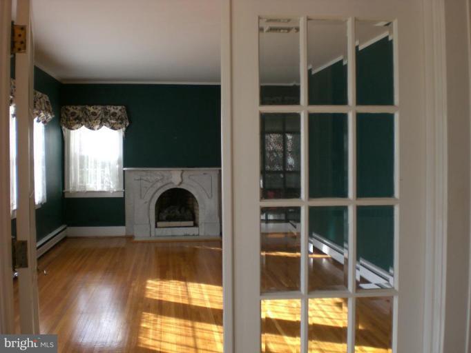 829 Buckingham Road Cumberland, MD 21502 - Photo 2 of 25 Gas fireplace with marble mantel, wood floors