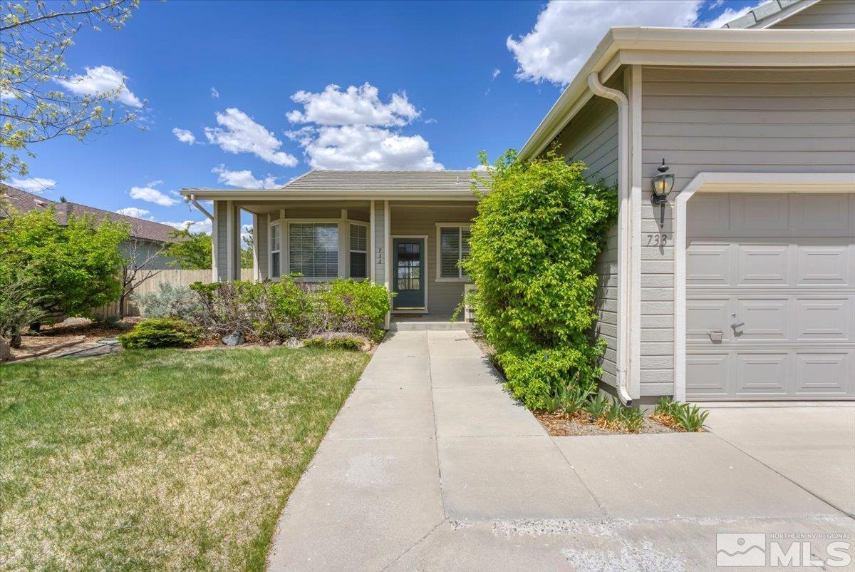 733 Gold River Court Reno, NV 89521 - Photo 3 of 26 a view of a house with brick walls and a yard with plants