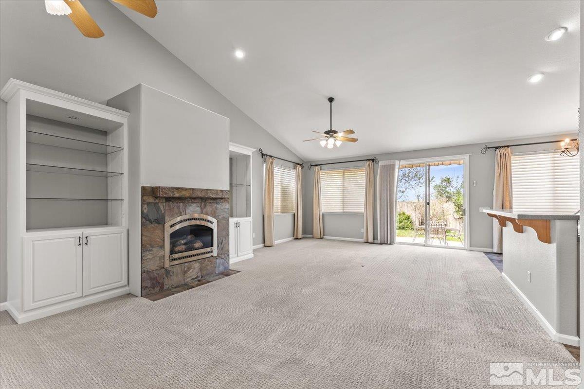 733 Gold River Court Reno, NV 89521 - Photo 8 of 26 a view of an empty room with a fireplace and a window