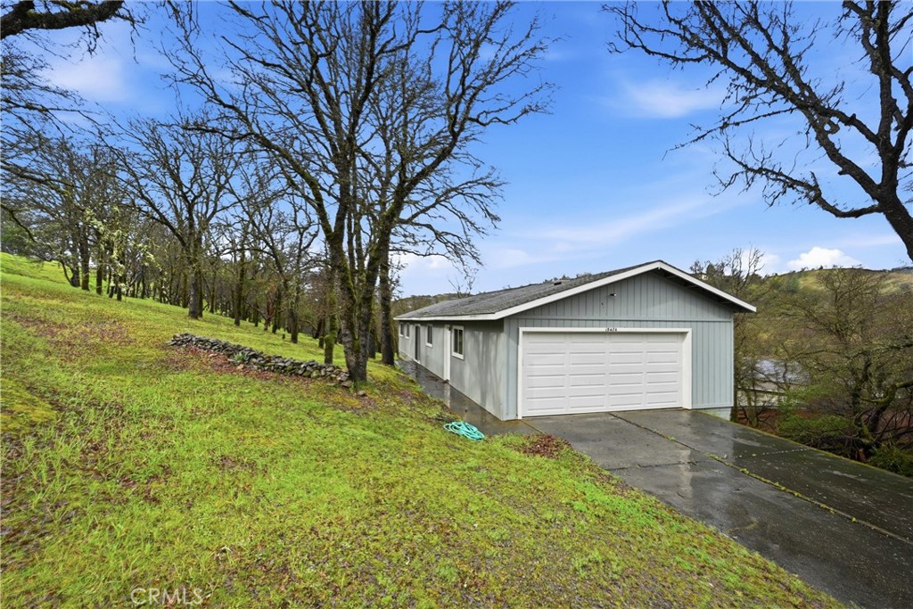 19474 Donkey Hill Road Hidden Valley Lake, CA 95467 - Photo 31 of 38 a white house that has a tree in front of it
