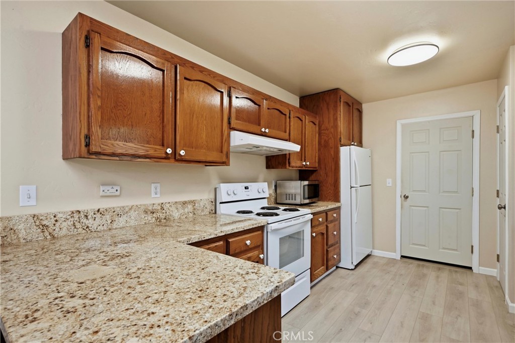 19474 Donkey Hill Road Hidden Valley Lake, CA 95467 - Photo 6 of 38 a kitchen with stainless steel appliances granite countertop a stove a sink and a refrigerator