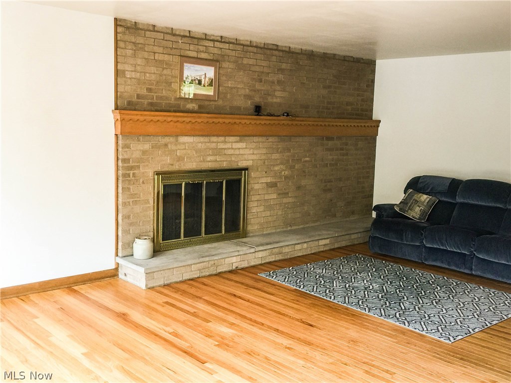 577 Garnette Road Akron, OH 44313 - Photo 10 of 22 Brick fireplace in living room. Hardwood floors in living room, dining room, hallways, and 3 of the 4 bedrooms.