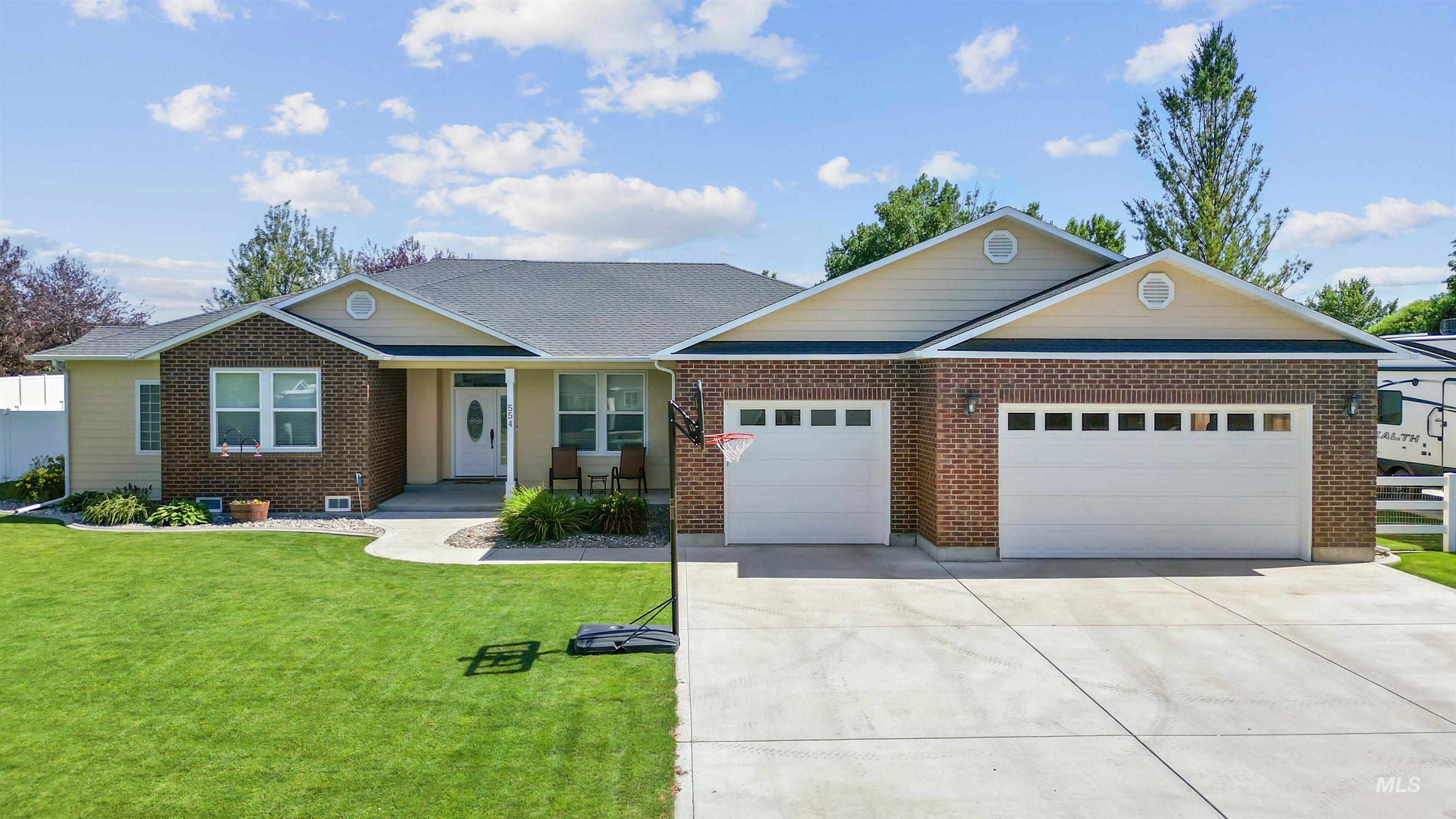 554 Valley Circle Road Hagerman, ID 83332 - Photo 1 of 1 Single story home featuring an attached garage, driveway, a front lawn, and brick siding