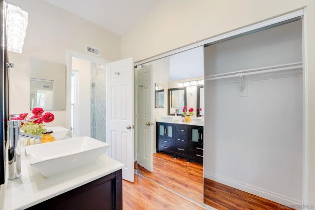 a bathroom with a sink double vanity and a mirror