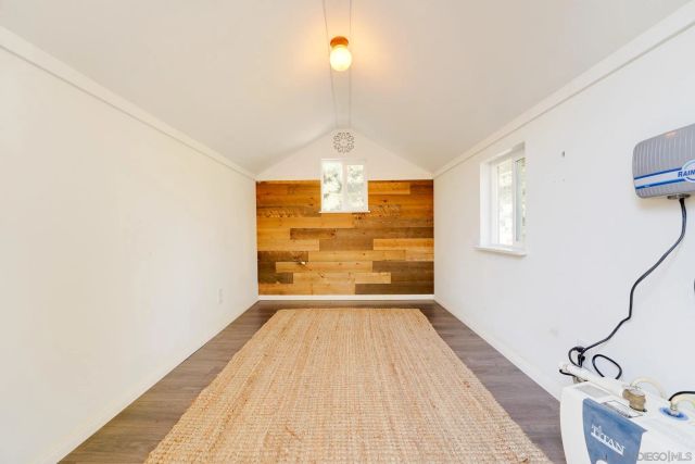 a view of a house with a yard potted plants and large tree